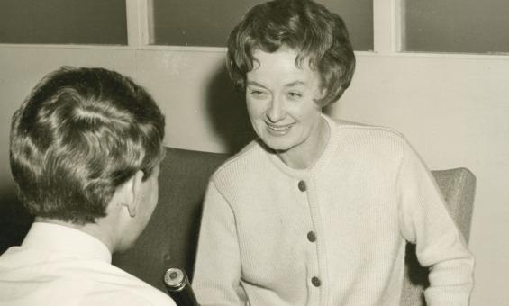 Sepia-toned photo of oral historian Hazel de Berg smiling while interviewing Michael Terry
