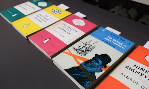 Five differently-colour books laid out in a row, all published by Penguin Random House and featuring their well known cover design