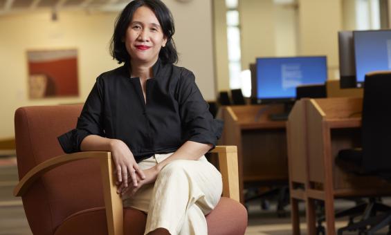 Rima Febriani sitting on an armchair in the Main Reading Room