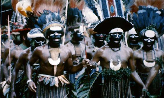 Group of Papua New Guineans in traditional dress, including feathered headpieces, at the Independence Day Celebration.