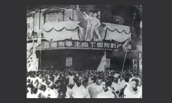 A black and white image of Chinese students crowded outside a theatre for a meeting in 1949