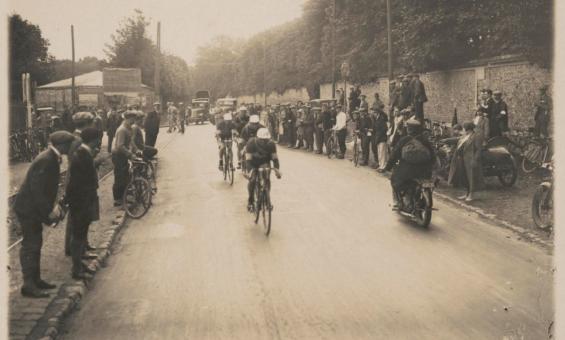 Cyclists racing on a road lined with spectators